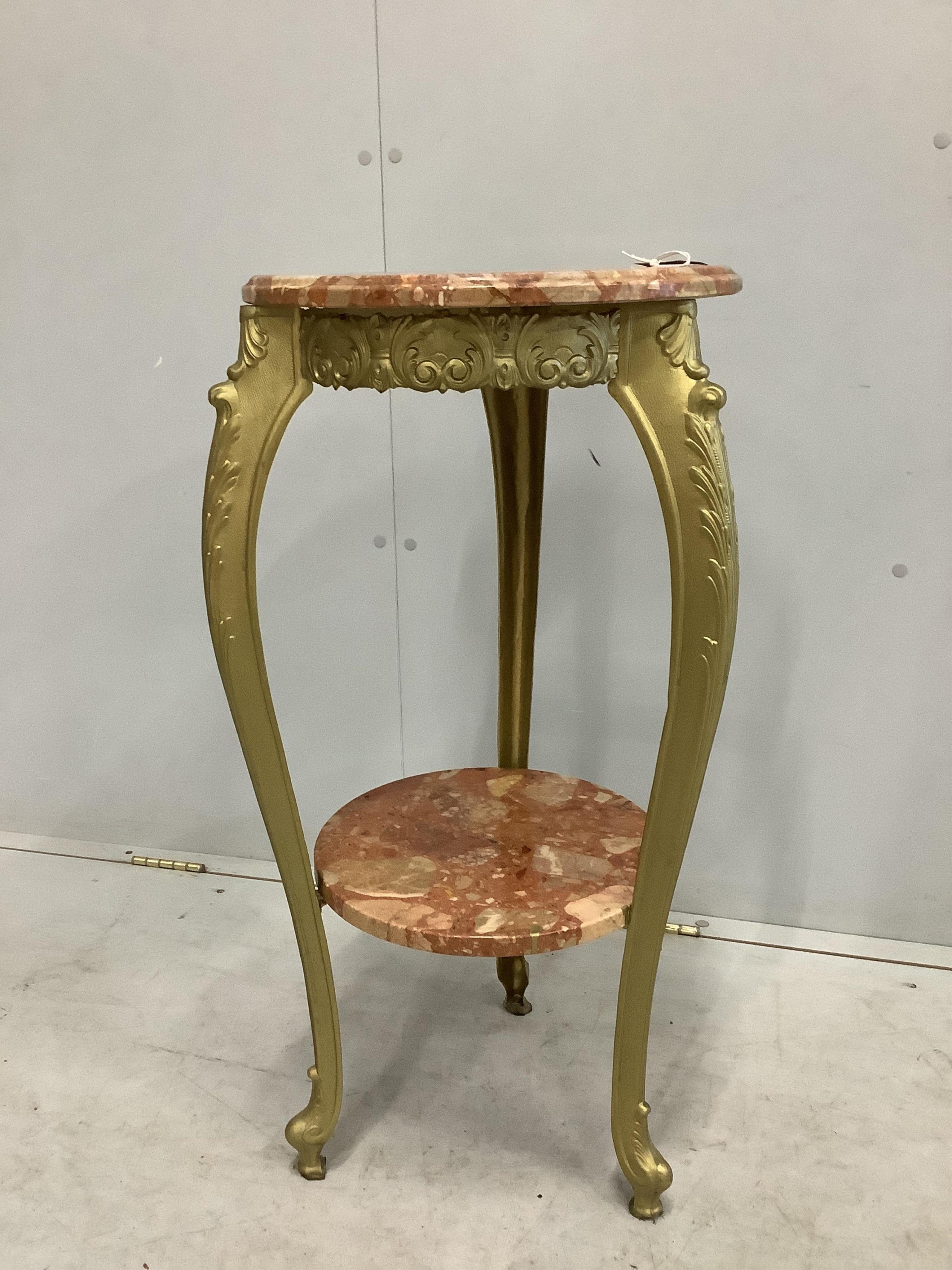 An early 20th century French circular reconstituted marble and cast metal two tier table, diameter 38cm, height 79cm. Condition - good